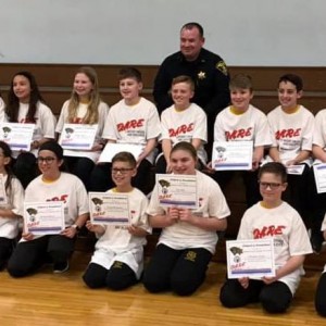 Our 5th graders D.A.R.E. graduates showing of their certificates.